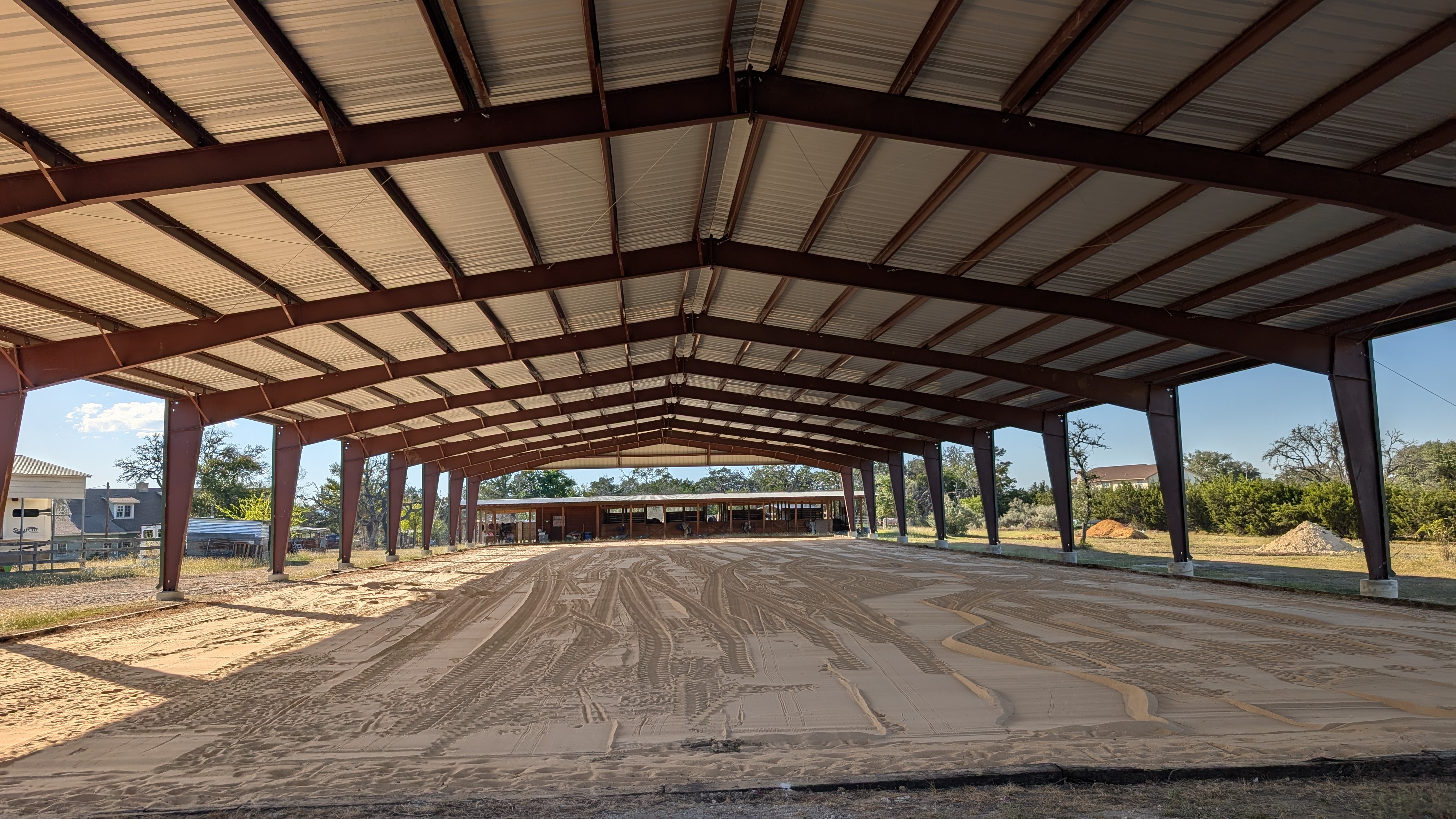Interior view of a covered horse riding arena in Boerne, Texas